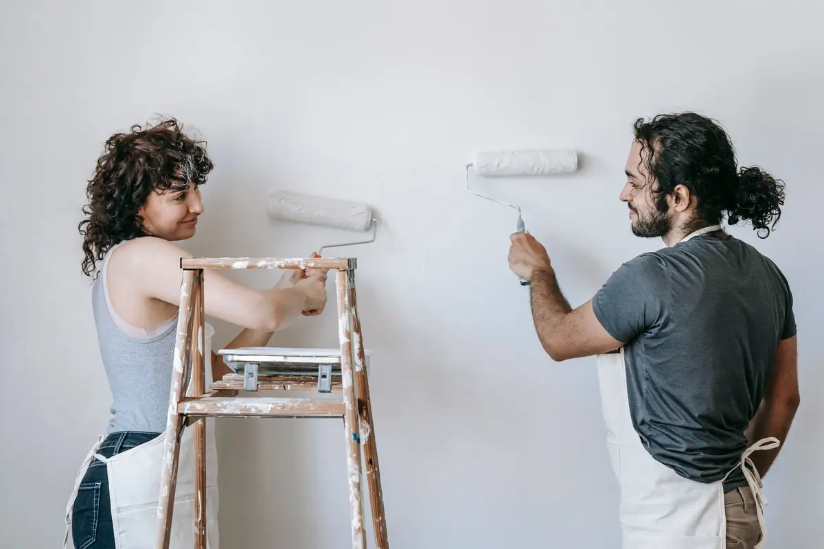 People painting a wall together — painting help in Norfolk
